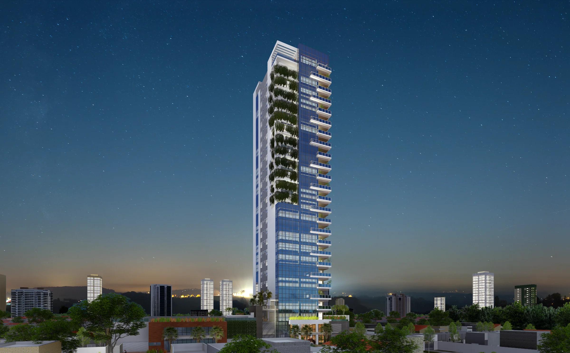 Fachada ao anoitecer com iluminação cênica na entrada e na torre