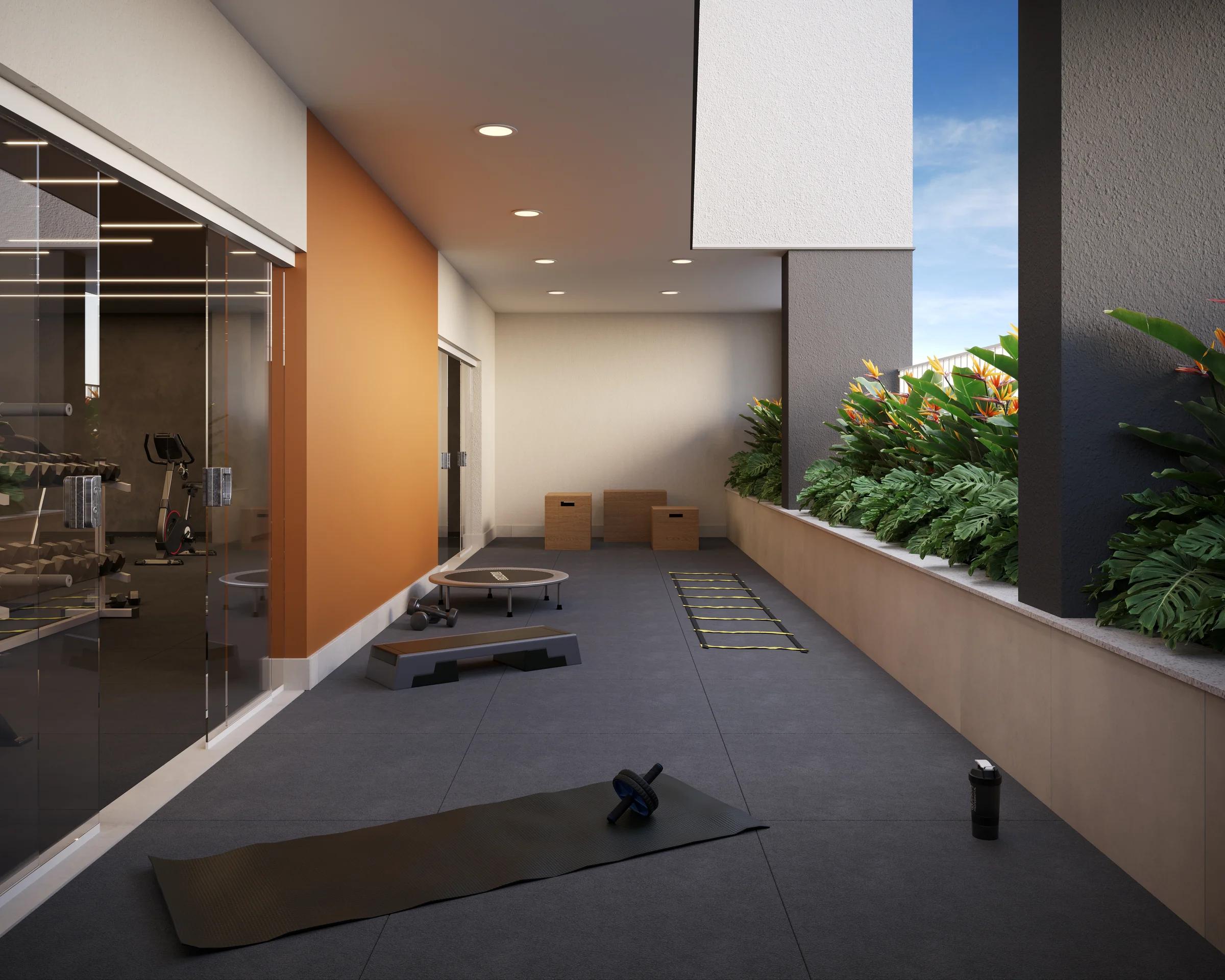 Espaço fitness ao ar livre com colchonetes, estepe e área de treino funcional