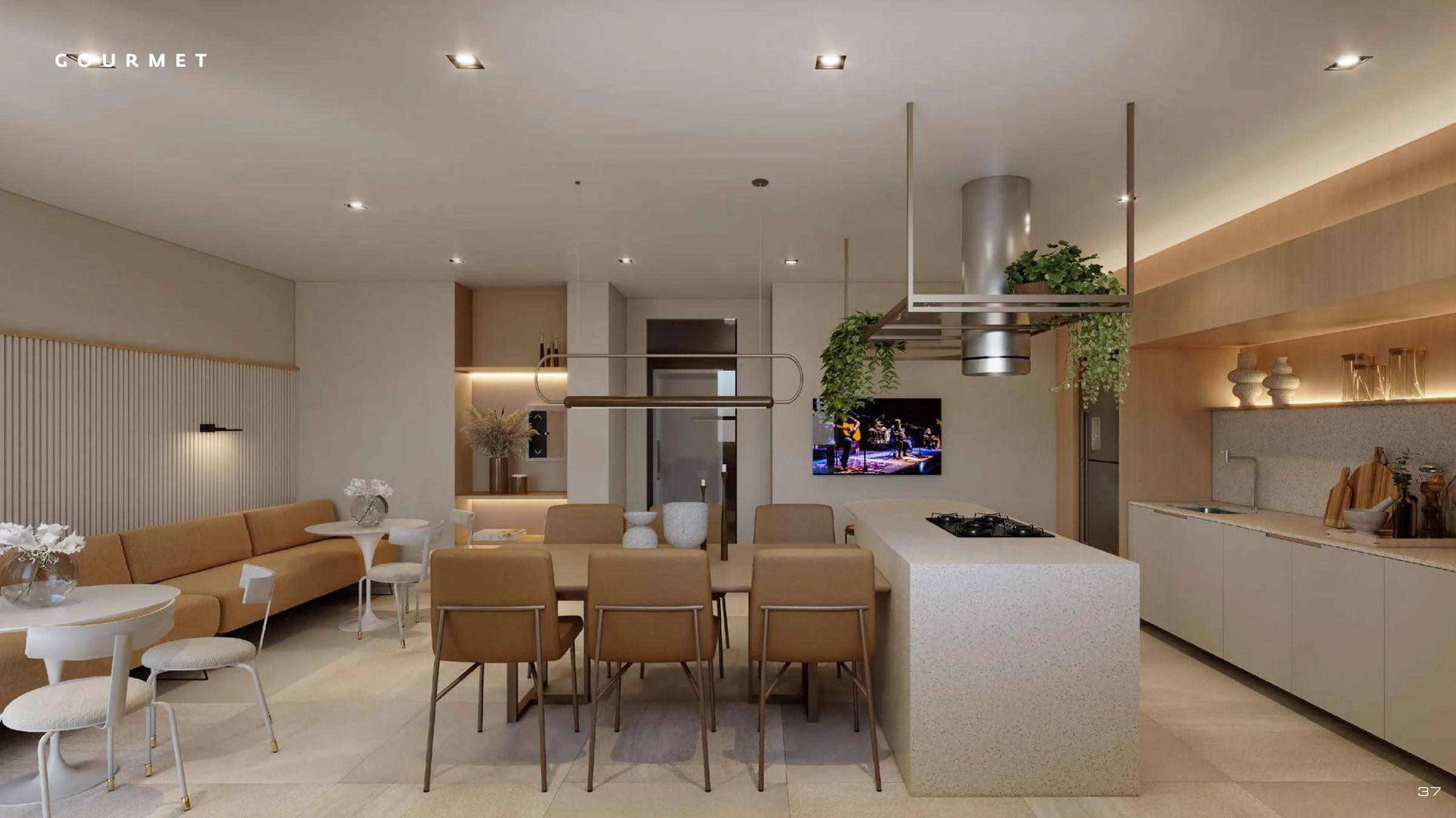 Espaço gourmet com bancada em ilha, cooktop, mesa de jantar e sofá integrado.