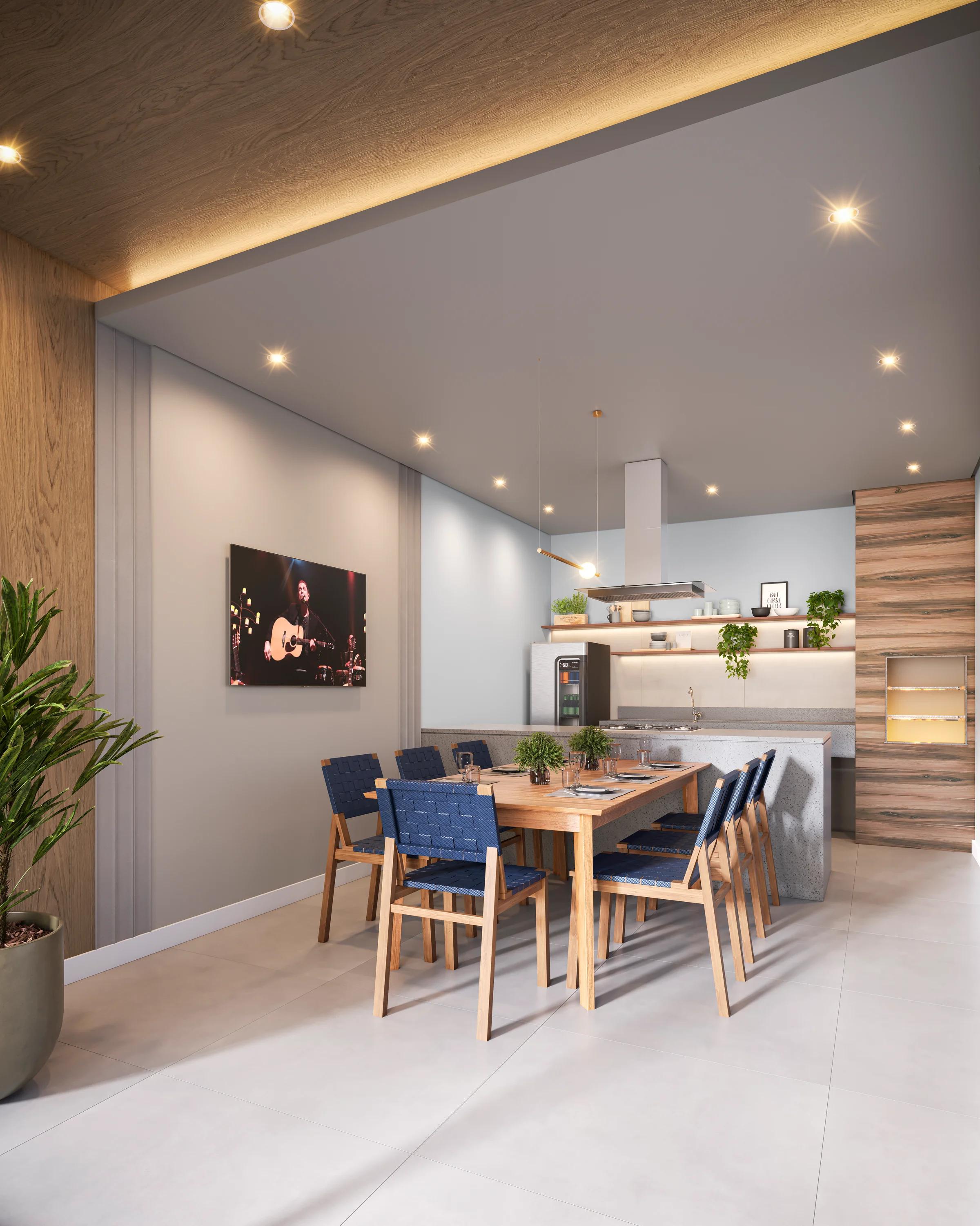 Espaço gourmet com bancada, cooktop e mesa para oito lugares