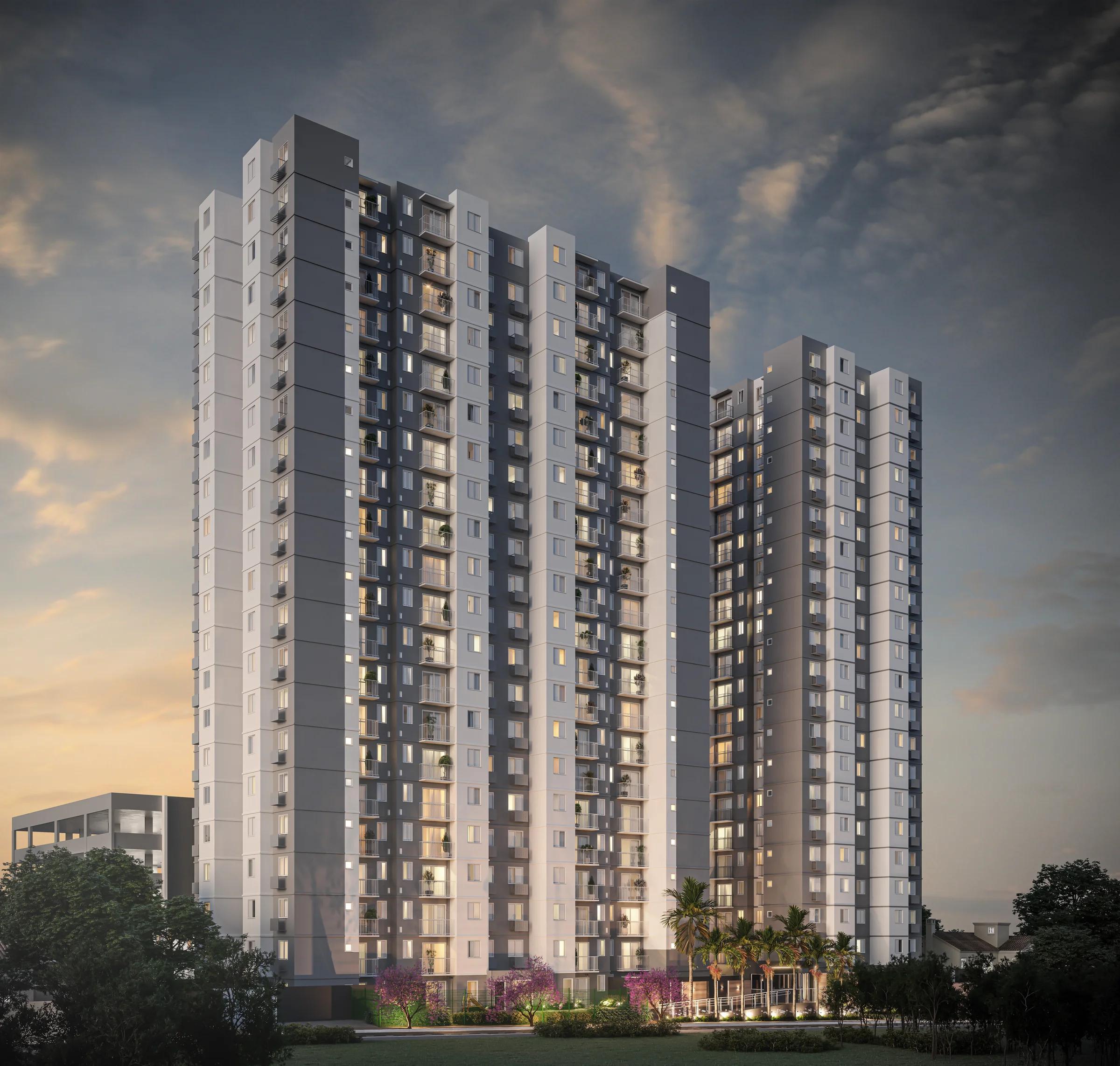 Fachada completa das torres residenciais ao entardecer com iluminação externa