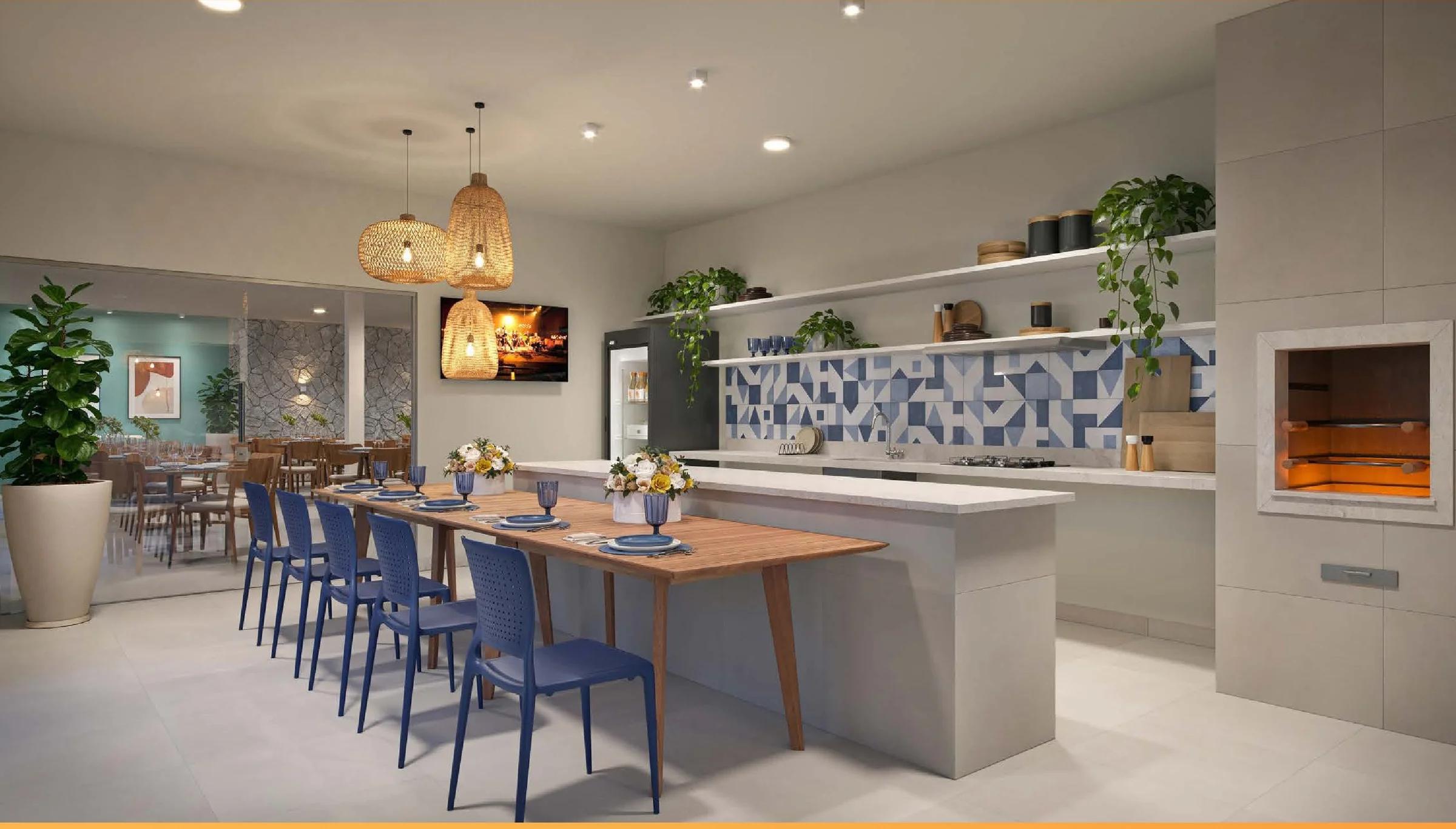 Espaço gourmet integrado com bancada, mesa de jantar e churrasqueira