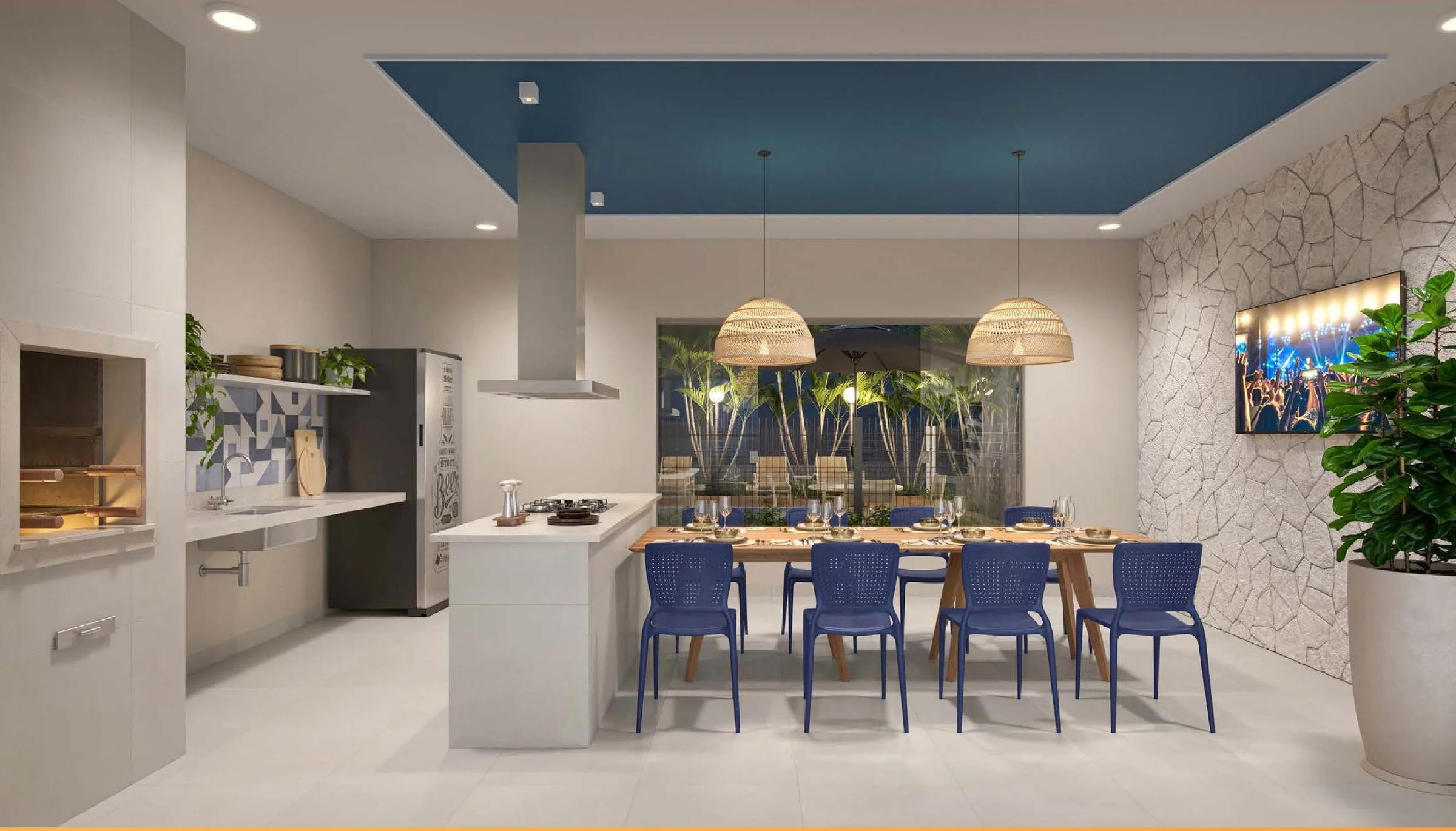 Varanda gourmet com churrasqueira, bancada com cooktop e mesa para refeições