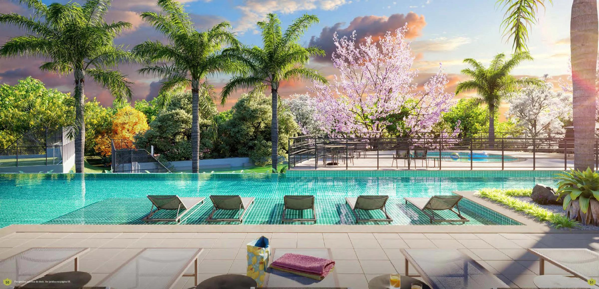 Deck molhado com espreguiçadeiras na piscina e vista para a vegetação