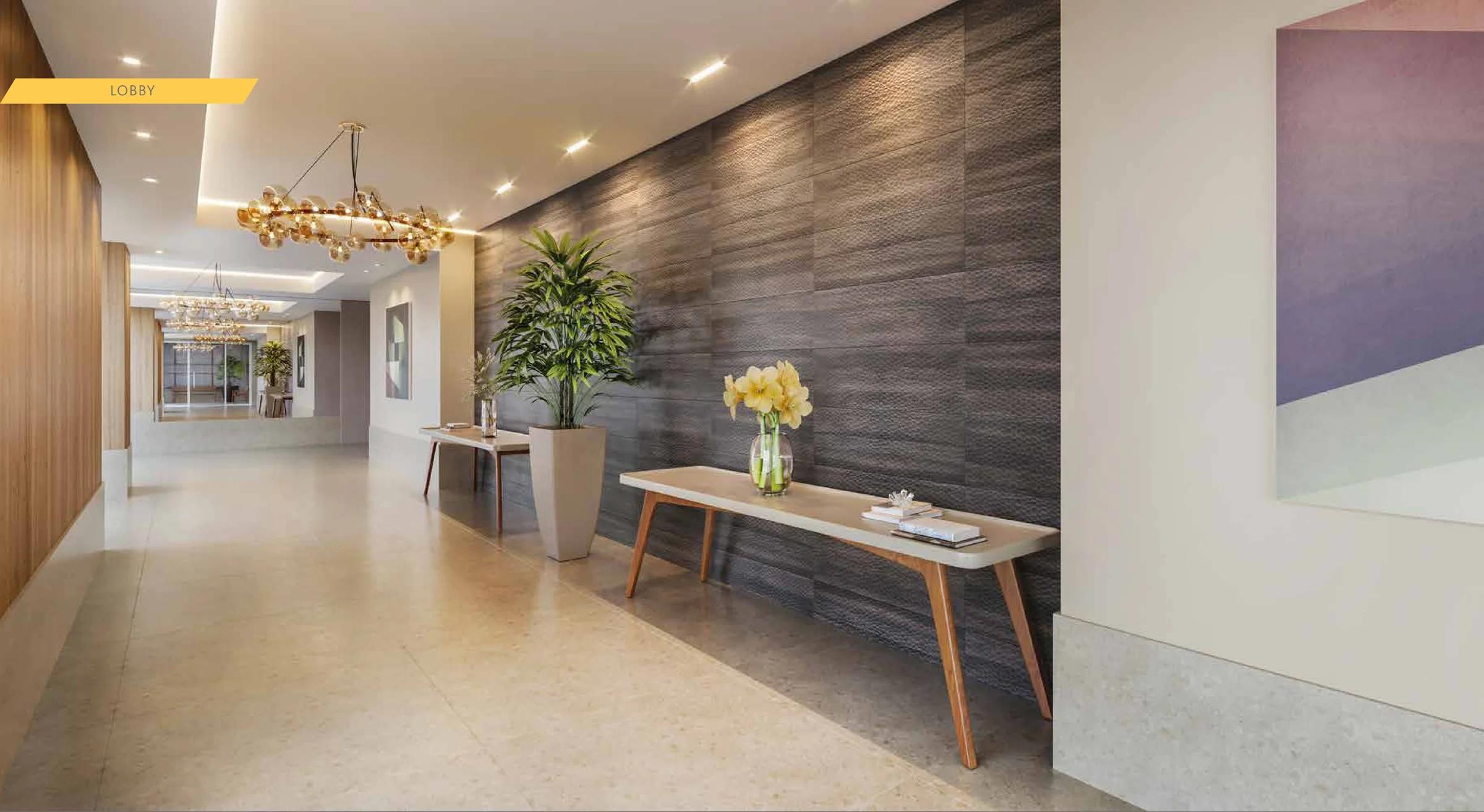 Lobby de entrada com parede texturizada, aparador e lustre moderno