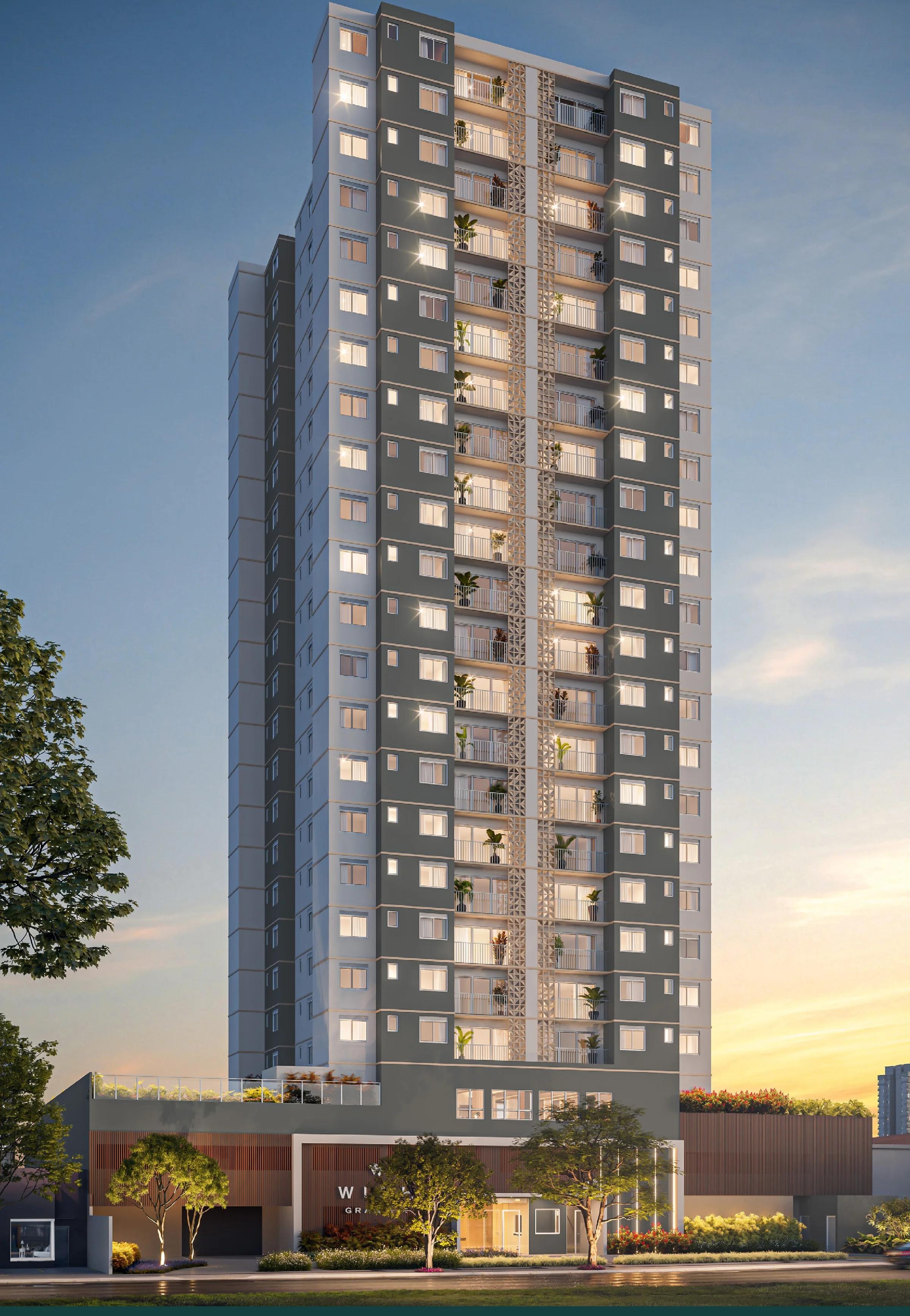 Perspectiva da fachada completa da torre residencial em formato vertical ao entardecer