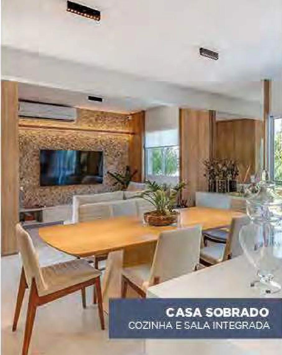 Sala de estar e jantar integradas do sobrado decorado com painel de TV