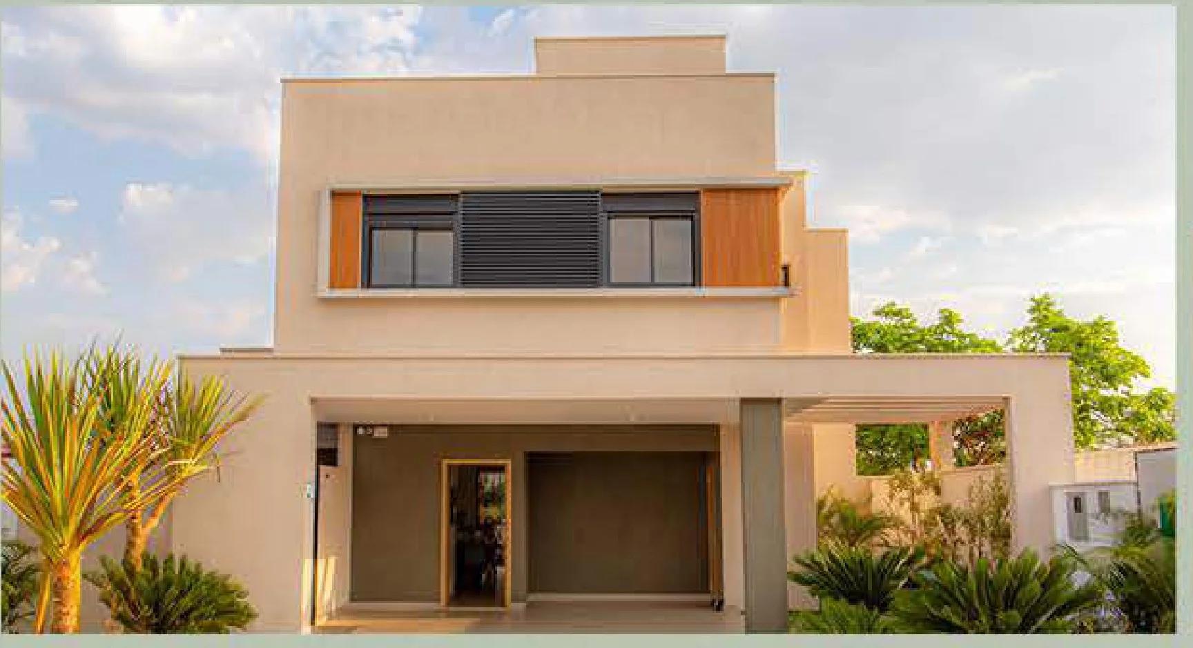 Fachada frontal da casa modelo com dois pavimentos, garagem coberta e paisagismo