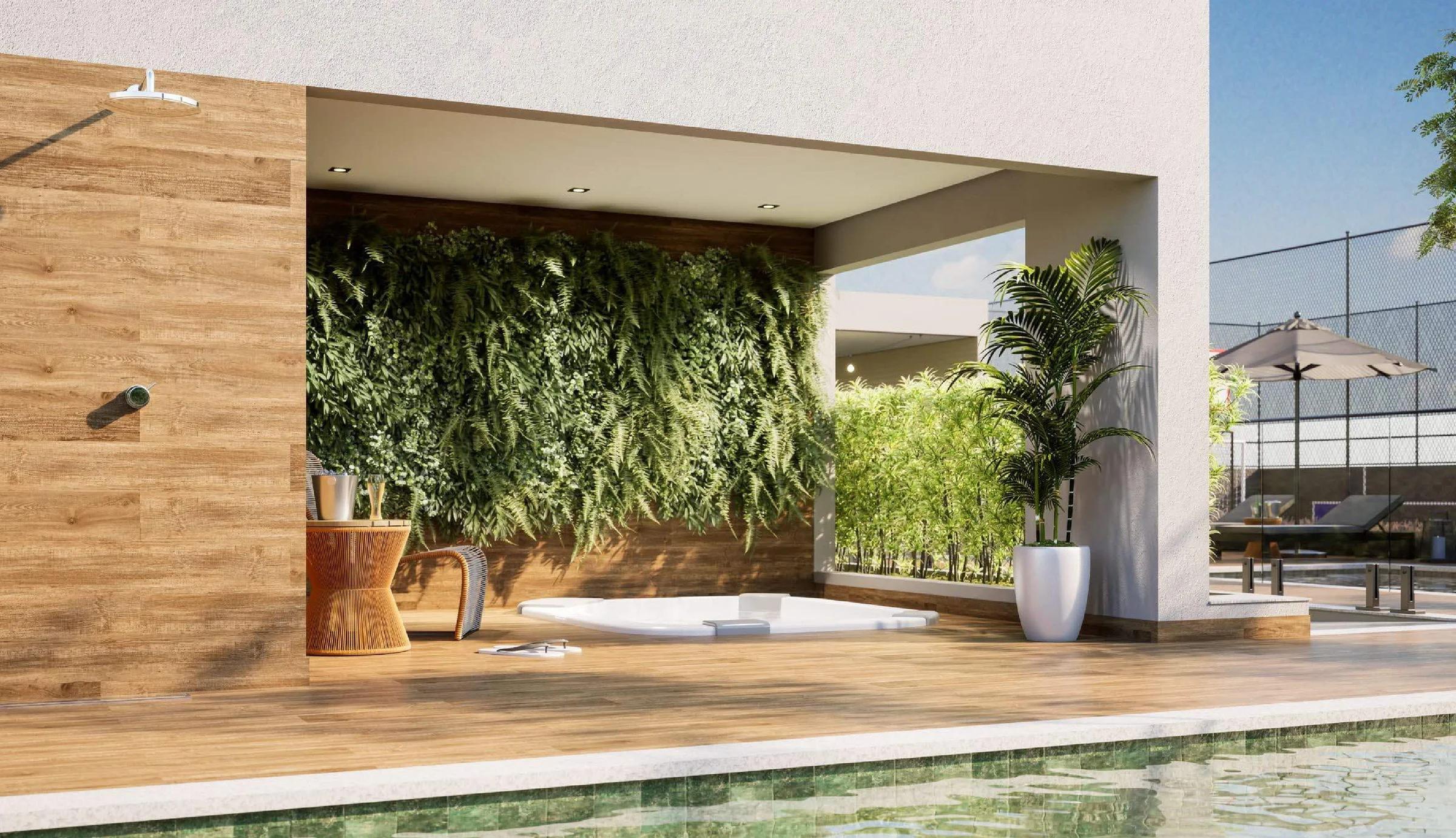 Área de relaxamento com banheira de hidromassagem e jardim vertical ao lado da piscina