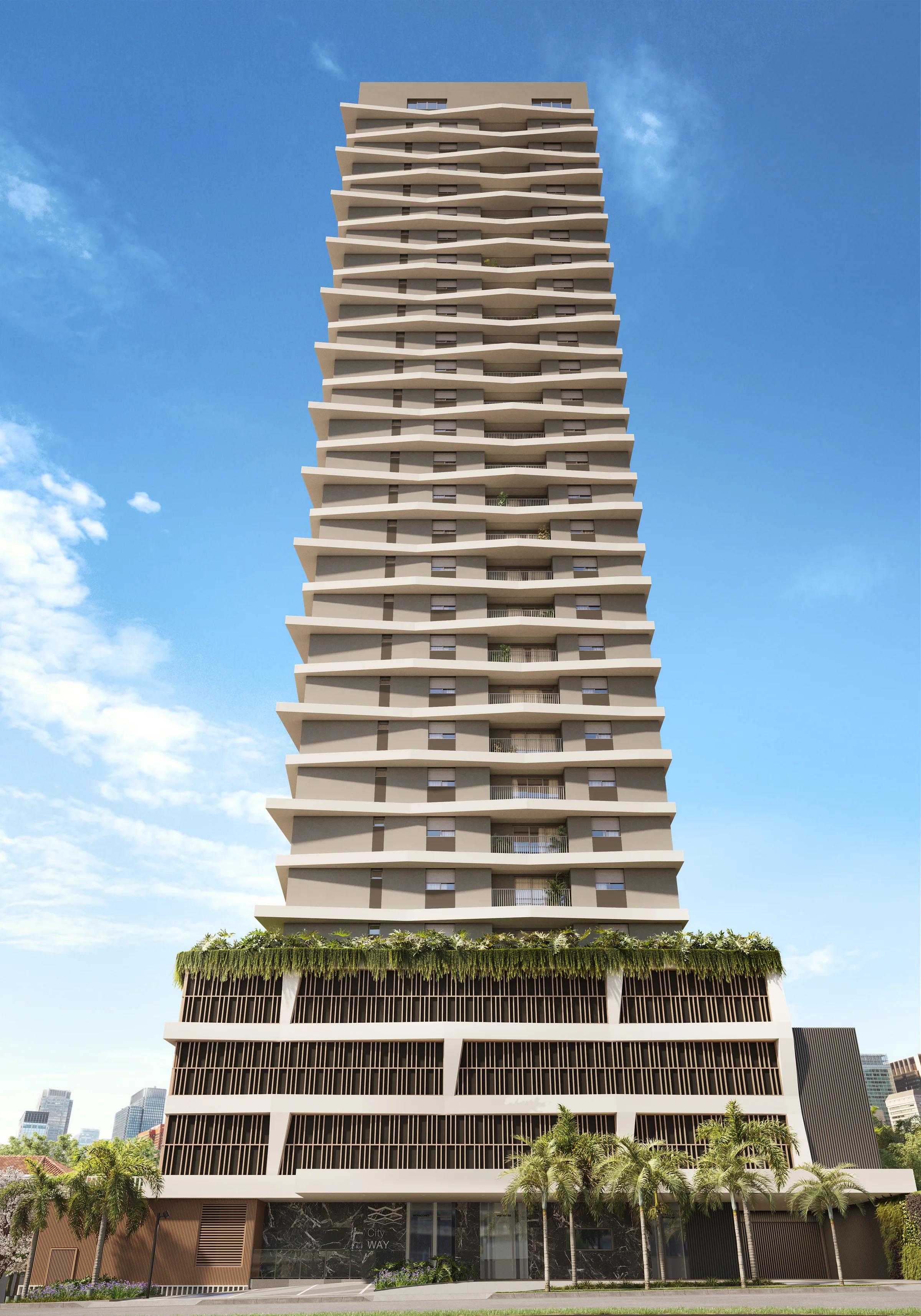 Fachada do edifício vista frontalmente com céu azul e vegetação na base