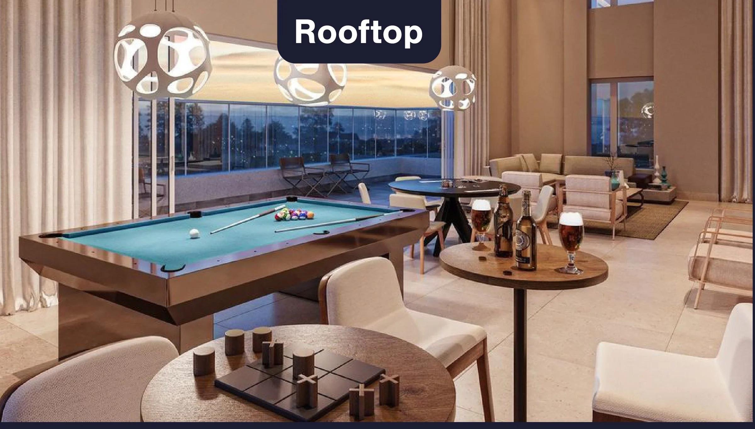 Espaço rooftop com mesa de sinuca, mesas de jogos e área de estar com vista panorâmica