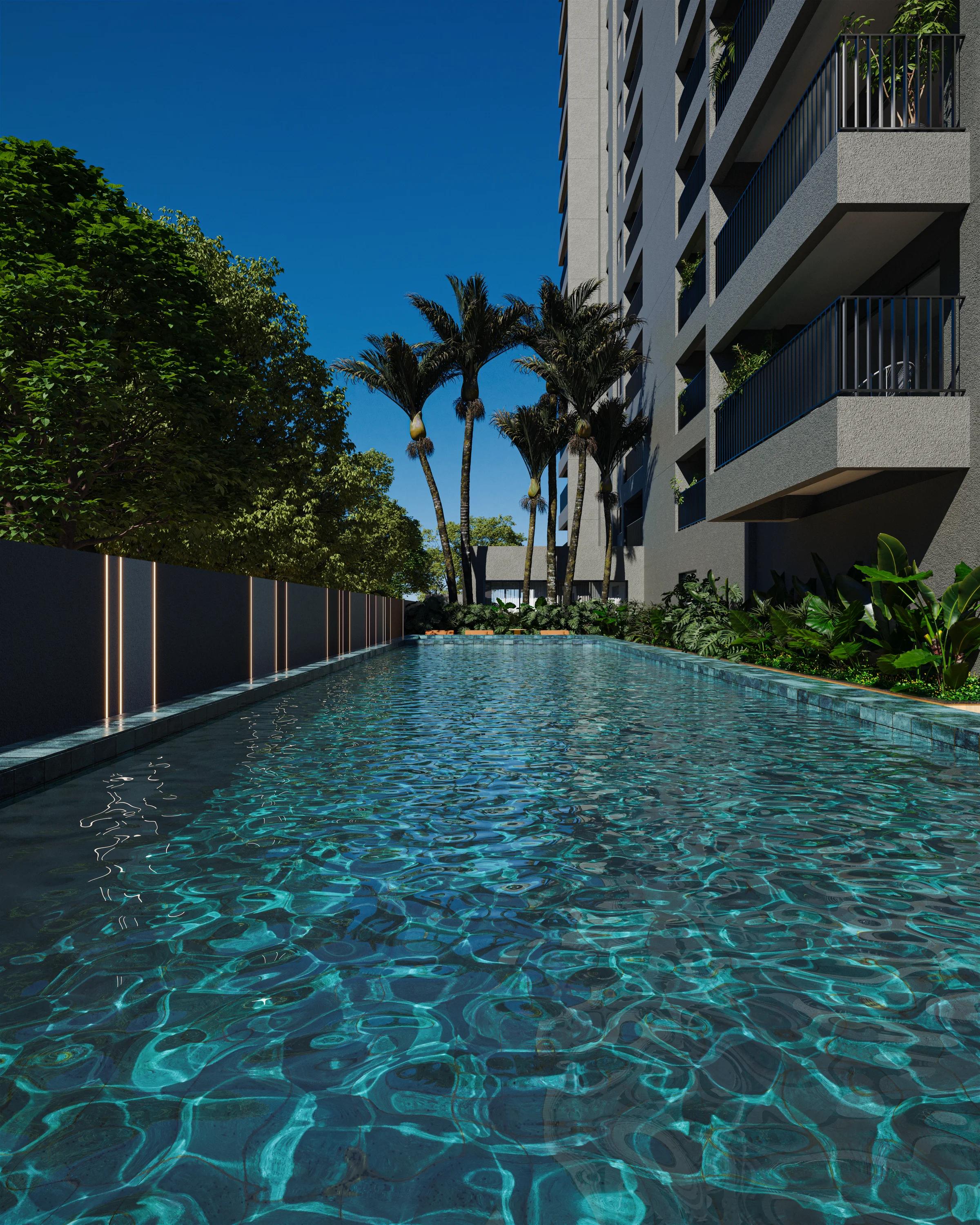 Piscina adulto com raia de 14,5 metros cercada por paisagismo e iluminação embutida